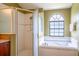 Bathroom with a shower/tub combo and an arched window at 3011 Indian Trl, Eustis, FL 32726