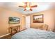 Bedroom with queen bed, large art piece, and ceiling fan at 3011 Indian Trl, Eustis, FL 32726