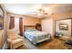 Bedroom with a queen bed, recliner chair, and large mirror at 3011 Indian Trl, Eustis, FL 32726