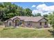 One-story home with stone accents and landscaped yard at 3011 Indian Trl, Eustis, FL 32726