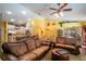 Open living room with leather sofas and a view into the kitchen at 3011 Indian Trl, Eustis, FL 32726