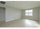 Spacious living room with large window and light wood flooring at 5814 Wallis Ln, Saint Cloud, FL 34771