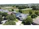 Aerial view showcasing a house with solar panels and a neighborhood setting at 184 Bayou Bend Rd, Groveland, FL 34736