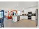 Open concept kitchen with stainless steel appliances and breakfast bar at 4189 Paragraph Dr, Kissimmee, FL 34746