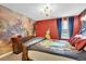 Spacious bedroom featuring a king-size bed and a captivating mural at 4189 Paragraph Dr, Kissimmee, FL 34746