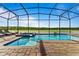 Enjoy this relaxing pool and spa with a screened enclosure and lake view at 4189 Paragraph Dr, Kissimmee, FL 34746