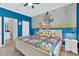 Bright bedroom with Donald Duck wall art and en suite at 4189 Paragraph Dr, Kissimmee, FL 34746