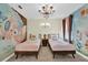 Charming bedroom with twin beds, themed wallpaper, and decorative accents at 4189 Paragraph Dr, Kissimmee, FL 34746