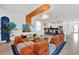 Open living area with a sectional sofa and large TV, boasting a unique color scheme at 4189 Paragraph Dr, Kissimmee, FL 34746