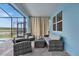 Relaxing patio with wicker furniture and view of the pool and lake at 4189 Paragraph Dr, Kissimmee, FL 34746