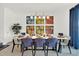 Bright dining room with modern table and chairs, featuring stylish artwork at 4189 Paragraph Dr, Kissimmee, FL 34746