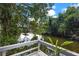 Serene waterfront view from a wooden dock, surrounded by trees at 12270 Virginia Dr, Leesburg, FL 34788