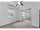 Spacious bedroom with mirrored closet doors and ceiling fan at 12270 Virginia Dr, Leesburg, FL 34788