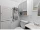 Clean bathroom with white vanity, toilet and storage cabinets at 12270 Virginia Dr, Leesburg, FL 34788