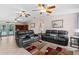 Spacious living room with leather sofas, ceiling fans, and access to the pool at 12270 Virginia Dr, Leesburg, FL 34788