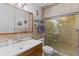 Bathroom with shower, vanity, and tiled walls at 12270 Virginia Dr, Leesburg, FL 34788