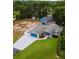 Aerial view of house with pool, detached garage, and waterfront lot at 12270 Virginia Dr, Leesburg, FL 34788