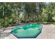 Inviting kidney-shaped pool surrounded by lush landscaping at 12270 Virginia Dr, Leesburg, FL 34788