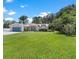 Large front yard with lush green grass and mature trees at 12270 Virginia Dr, Leesburg, FL 34788