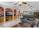 Open living room with a view of the kitchen and entertainment center at 12270 Virginia Dr, Leesburg, FL 34788