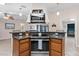 Island kitchen with stainless steel appliances and wood cabinets at 12270 Virginia Dr, Leesburg, FL 34788