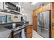 Updated kitchen with stainless steel appliances and wood cabinets at 12270 Virginia Dr, Leesburg, FL 34788