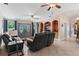 Bright living room featuring comfortable seating and double doors at 12270 Virginia Dr, Leesburg, FL 34788