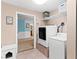 Laundry room with washer, dryer, and shelving at 12270 Virginia Dr, Leesburg, FL 34788
