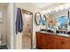 Bathroom with double vanity and walk-in shower at 12270 Virginia Dr, Leesburg, FL 34788