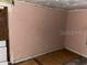 An interior room with damage to walls and floor needing repair at 1605 Rose Ln, Eustis, FL 32726