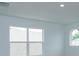 Bright bedroom with large window and neutral walls at 2368 Juniper Berry Dr, Minneola, FL 34715