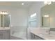 Bathroom with double vanity, soaking tub, and walk-in shower at 2368 Juniper Berry Dr, Minneola, FL 34715