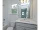 Bright bathroom with window, toilet and vanity at 2368 Juniper Berry Dr, Minneola, FL 34715