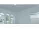 Spacious living room featuring abundant natural light from arched windows at 2368 Juniper Berry Dr, Minneola, FL 34715