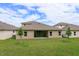Rear view of house, showcasing backyard and landscaping at 2368 Juniper Berry Dr, Minneola, FL 34715
