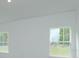 Bright bedroom with two windows and neutral walls at 2368 Juniper Berry Dr, Minneola, FL 34715