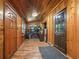 Long entry hallway with wood walls and floors at 2027 Cr 232, Wildwood, FL 34785