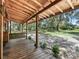 Wooden front porch overlooking a large backyard at 2027 Cr 232, Wildwood, FL 34785