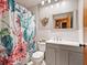 Bathroom with gray vanity, cactus shower curtain, and mirror at 2027 Cr 232, Wildwood, FL 34785