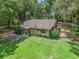 Rustic one-story home on a spacious lot with lush trees at 2027 Cr 232, Wildwood, FL 34785