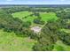 Aerial view of expansive property with lush green pastures and mature trees at 2027 Cr 232, Wildwood, FL 34785