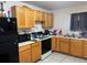 Small kitchen with wood cabinets at 1603 Rose Ln, Eustis, FL 32726