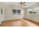 Bright bonus room with wood-look floors and ceiling fan at 1113 Oakland Cir, Tavares, FL 32778