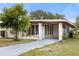 Ranch home with carport and nicely landscaped yard at 1113 Oakland Cir, Tavares, FL 32778