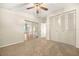 Bedroom with ceiling fan, carpet flooring, and mirrored closet doors at 1113 Oakland Cir, Tavares, FL 32778