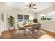 Bright dining room with wood floors and modern light fixture at 1113 Oakland Cir, Tavares, FL 32778