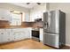 Bright kitchen with stainless steel appliances and wood flooring at 1113 Oakland Cir, Tavares, FL 32778