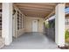 Inviting front porch with grey flooring and white door at 1113 Oakland Cir, Tavares, FL 32778
