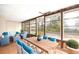 Sunroom with wooden table, wicker furniture, and plenty of natural light at 1113 Oakland Cir, Tavares, FL 32778