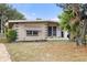 Mid-century home with updated landscaping and stone accents at 1113 Oakland Cir, Tavares, FL 32778